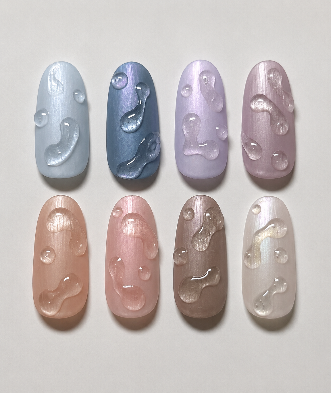 Acht künstliche Nägel in Pastellfarben mit schimmerndem Cat-Eye-Finish und transparentem 3D-Wassertropfen-Design
