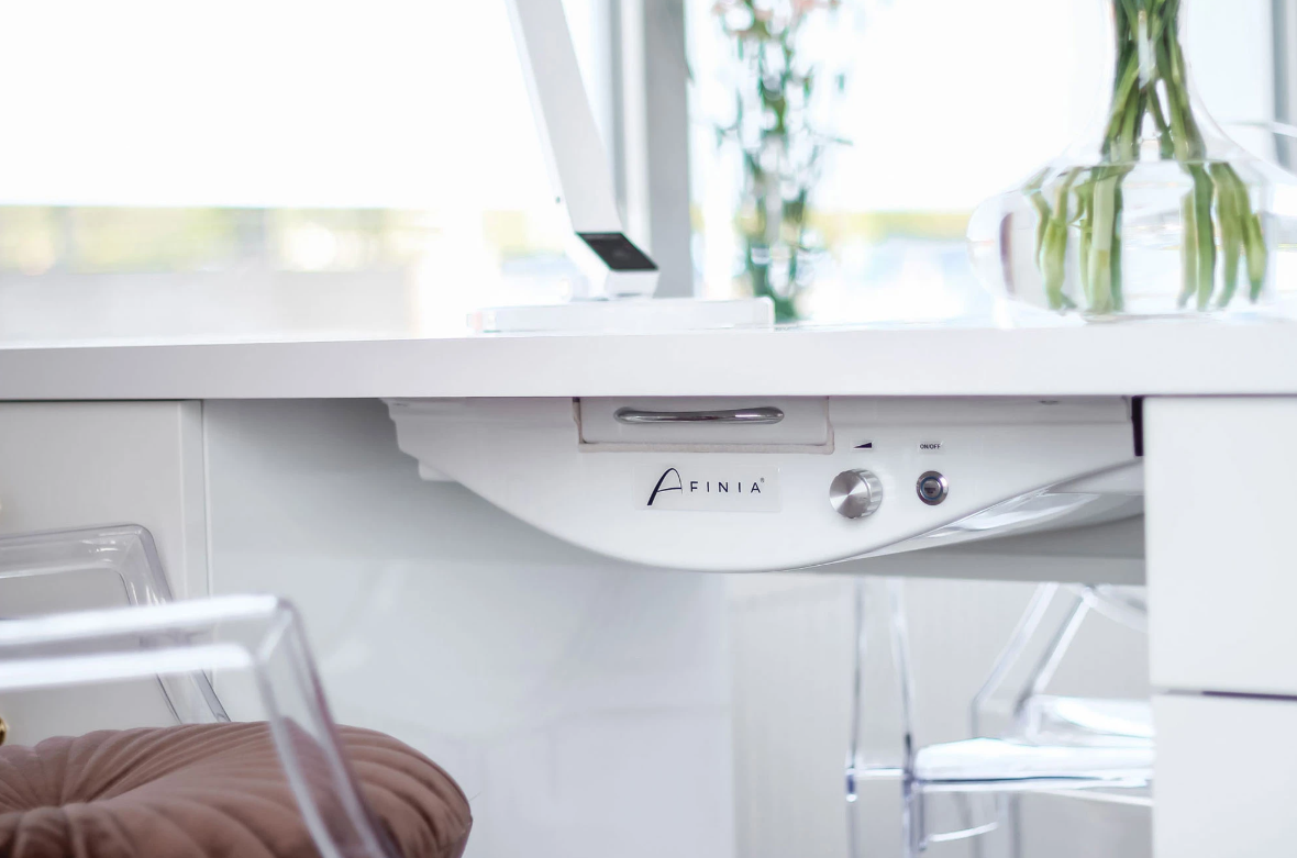 Weißer Schreibtisch mit eleganten Details und transparentem Stuhl