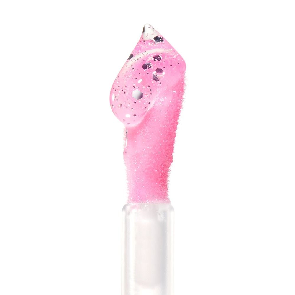 Nahaufnahme eines rosafarbenen Lipgloss mit Glitzer in einer transparenten Verpackung