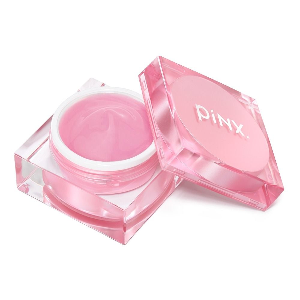 Offene Dose mit pinker Creme von PinX, die in einem transparenten Behälter präsentiert wird.