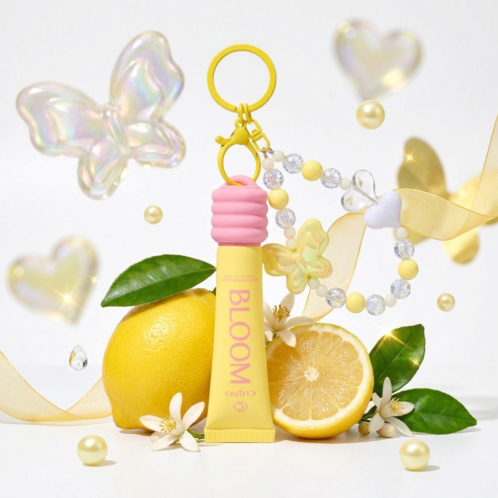 Gelber Bloom Lippenpflege-Schlüsselanhänger mit rosa Verschlusskappe, dekoriert mit Zitronen, Blüten, Perlenarmband und goldener Karabineröse