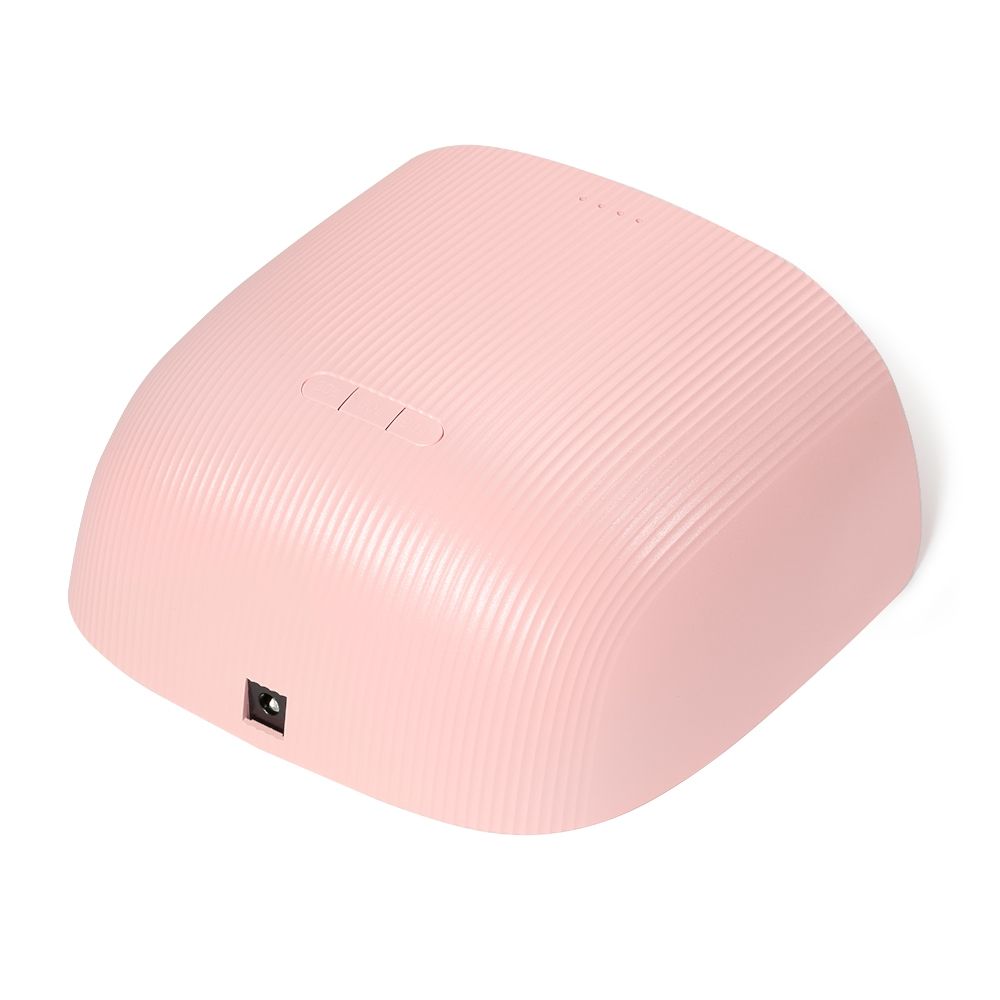 Kompakte rosa UV-/LED-Nagellampe für Gel-Nägel mit geriffeltem Gehäuse, Tasten oben und Stromanschluss an der Seite